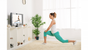 A female doing a yoga class from the comfort of her home led by a female personal trainer online